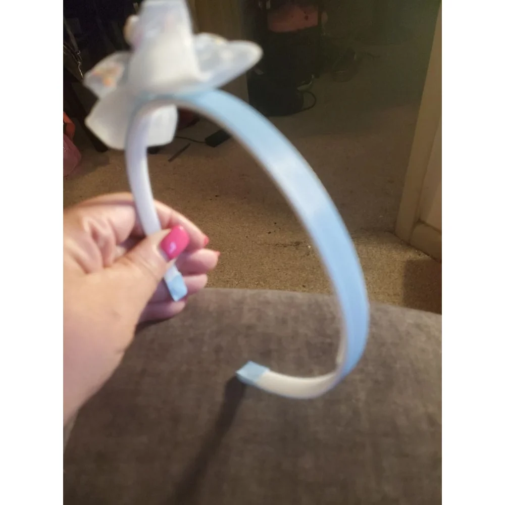 Four Hello Kitty headbands with small figurine